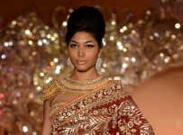 Model walks the ramp during the fashion designers Abu Jani and Sandeep Khosla fashion show The Golden Peacock in Mumbai on October 07, 2013. (Photo: IANS)