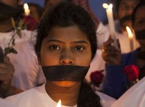 Indian women participate in a candle light vigil at a bus stop where the victim of a deadly gang rape in a moving bus had boarded the bus two years ago, in New Delhi, India, Tuesday, Dec. 16, 2014. The case sparked public outrage and helped make women’s safety a common topic of conversation in a country where rape is often viewed as a woman’s personal shame to bear. (AP Photo/Tsering Topgyal)