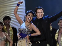 Bollywood actress Priyanka Chopra (L) dances and Hollywood actor John Travolta dance on stage during the fourth and final day of the 15th International Indian Film Academy (IIFA) Awards at the Raymond James Stadium in Tampa, Florida, April 26, 2014.AFP PHOTO/Jewel Samad