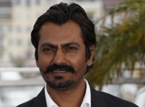 Indian actor Nawazuddin Siddiqui poses on May 18, 2013 during a photocall for the film "Monsoon Shootout" presented Out of Competition at the 66th edition of the Cannes Film Festival in Cannes. Cannes, one of the world's top film festivals, opened on May 15 and will climax on May 26 with awards selected by a jury headed this year by Hollywood legend Steven Spielberg. AFP PHOTO / VALERY HACHE