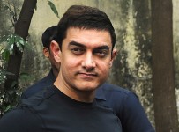Bollywood film actor Aamir Khan poses after a press conference in Mumbai on December 4, 2012.   Khan, dubbed as Indian cinema's Mr Perfectionist returned to the big screen in his first commercial film release for three years, taking up the role of a mustachioed police inspector in a Mumbai crime thriller "Talaash" (Search).  Earlier this year Khan launched a 13-episode Sunday morning television show that won plaudits for tackling some of India's darkest social problems, drawing comparisons between him and US chat show host Oprah Winfrey.  AFP PHOTO/INDRANIL MUKHERJEE